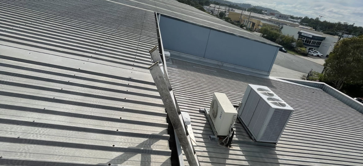 Commercial roof with vents and fan. Maintained by professional gutter cleaning service